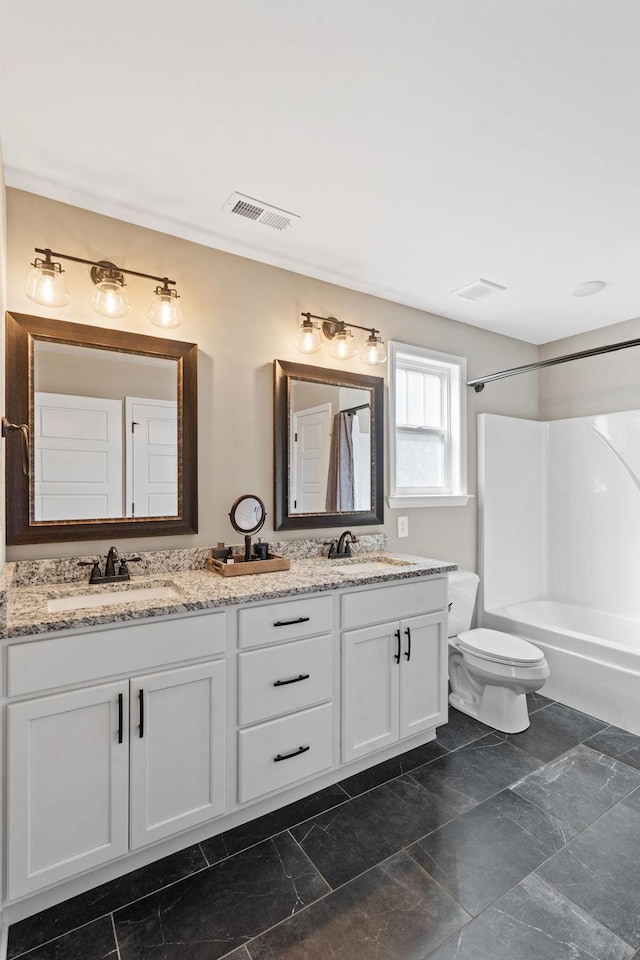 full bathroom featuring toilet, vanity, and shower / bathtub combination