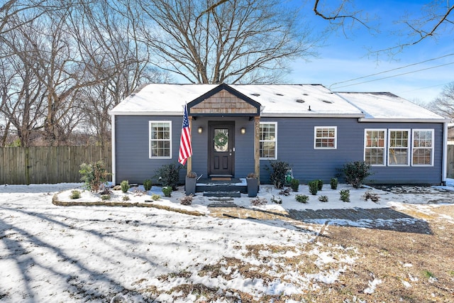 bungalow-style home with fence