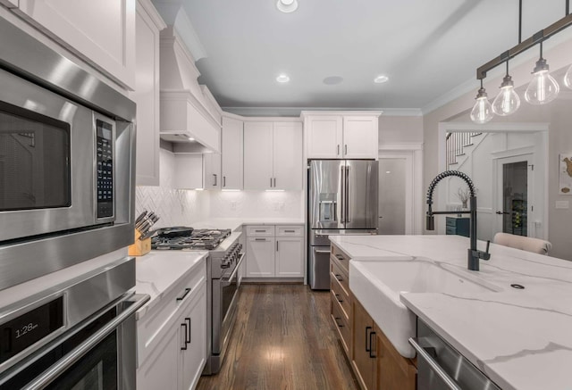 kitchen featuring sink, white cabinetry, appliances with stainless steel finishes, and light stone counters