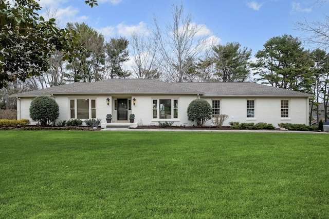 single story home featuring brick siding and a front lawn