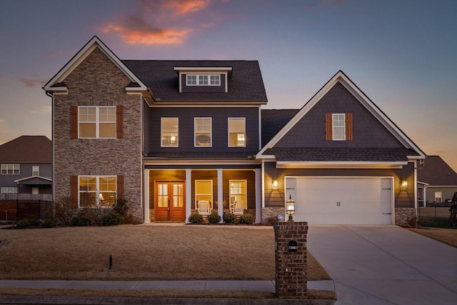 craftsman house with a garage and a porch