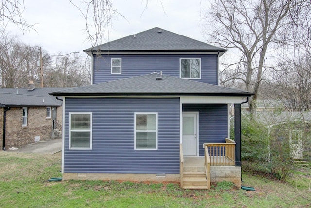 rear view of property with a shingled roof and crawl space