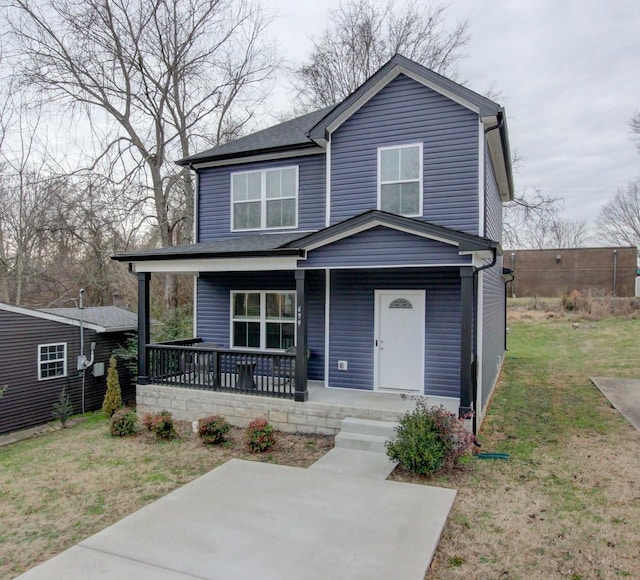 traditional-style house featuring a porch and a front lawn