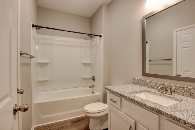 full bathroom with vanity, toilet, wood finished floors, and bathing tub / shower combination