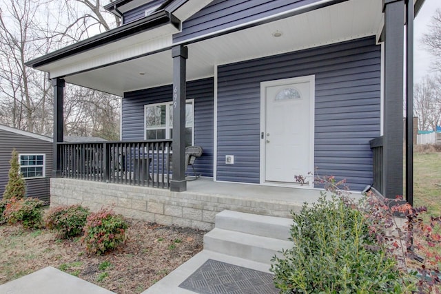 view of exterior entry with a porch