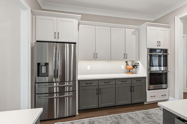 kitchen with light countertops, white cabinetry, appliances with stainless steel finishes, and gray cabinets