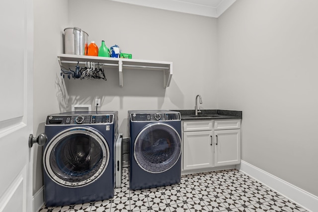 laundry room featuring baseboards, a sink, independent washer and dryer, cabinet space, and light floors
