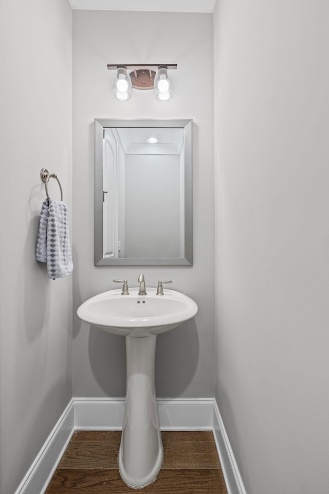 bathroom with baseboards and wood finished floors