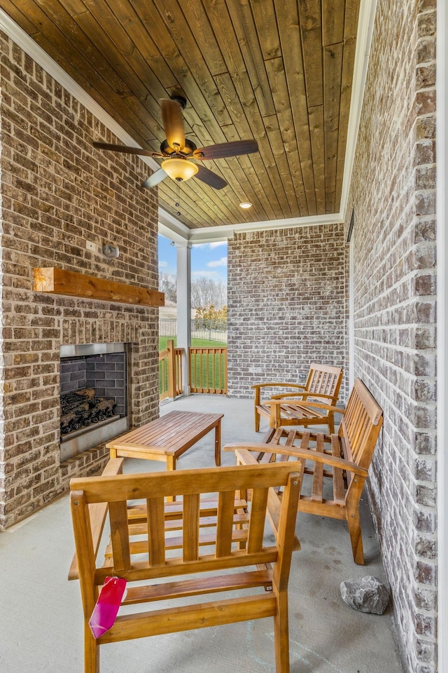 view of patio / terrace featuring an outdoor brick fireplace and a ceiling fan