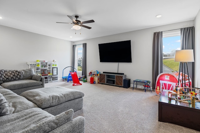living room with carpet flooring, baseboards, a ceiling fan, and recessed lighting