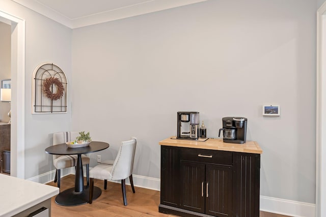dining space featuring baseboards and light wood-style floors