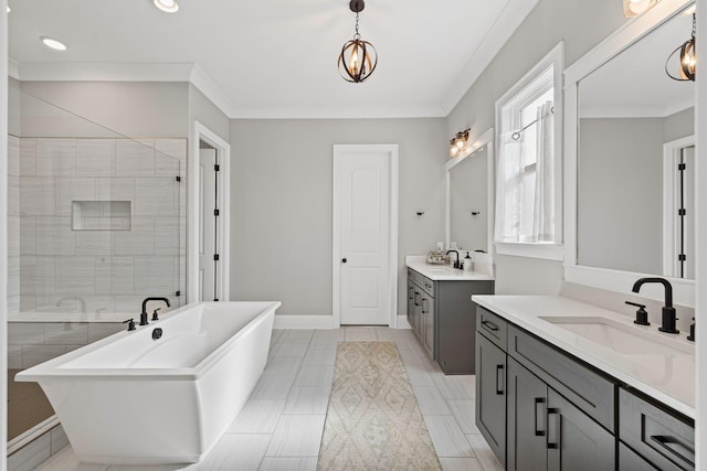 full bath featuring a sink, a freestanding bath, baseboards, and crown molding