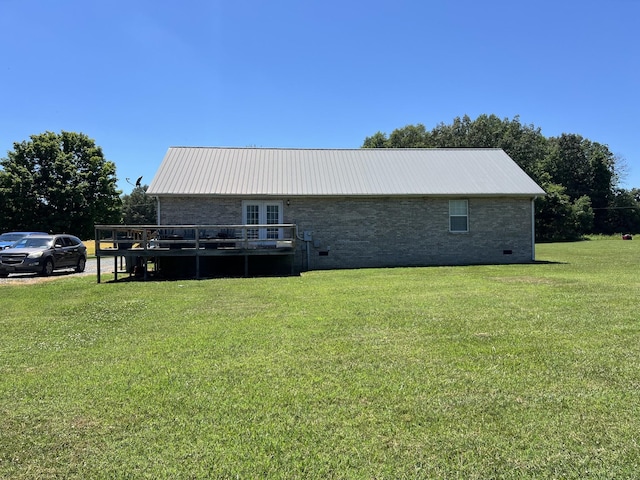 back of house with metal roof, a yard, crawl space, and a wooden deck