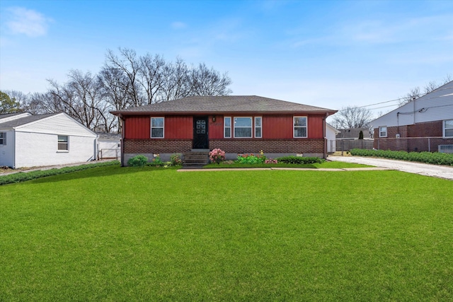 ranch-style house featuring roof with shingles, fence, a front lawn, board and batten siding, and brick siding