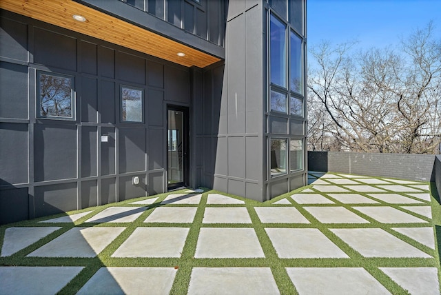 304 35th Ave N, Nashville, TN 37209 - property entrance featuring board and batten siding, a patio, and fence