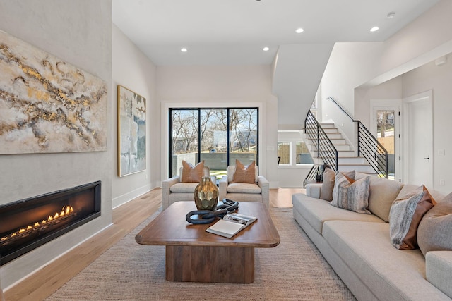 304 35th Ave N, Nashville, TN 37209 - living area featuring light wood-style floors, a glass covered fireplace, recessed lighting, and stairway