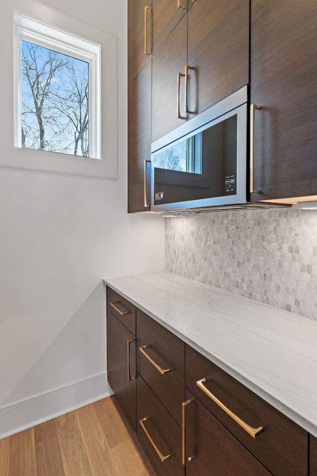 304 35th Ave N, Nashville, TN 37209 - bathroom featuring wood finished floors, baseboards, and backsplash