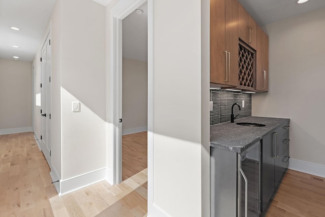 304 35th Ave N, Nashville, TN 37209 - bar featuring decorative backsplash, baseboards, a sink, light wood-type flooring, and recessed lighting