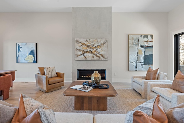 304 35th Ave N, Nashville, TN 37209 - living area featuring baseboards, a lit fireplace, and light wood-style flooring