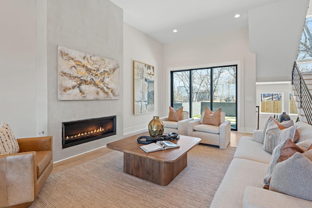 304 35th Ave N, Nashville, TN 37209 - living area with light wood-style flooring, a glass covered fireplace, recessed lighting, and a high ceiling