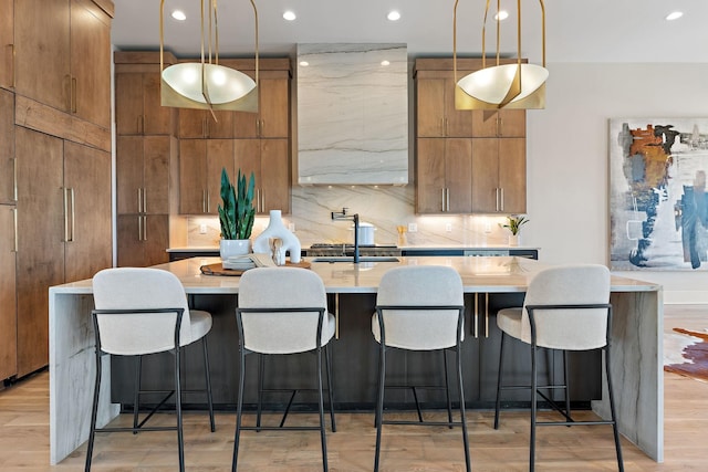 304 35th Ave N, Nashville, TN 37209 - kitchen featuring a sink, hanging light fixtures, tasteful backsplash, and a large island with sink