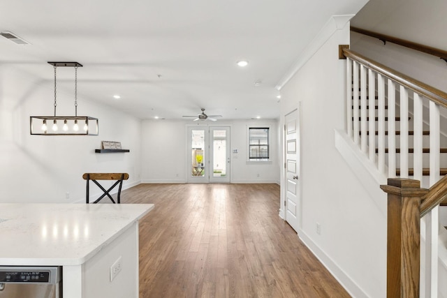 kitchen with wood finished floors, visible vents, baseboards, ceiling fan, and dishwasher