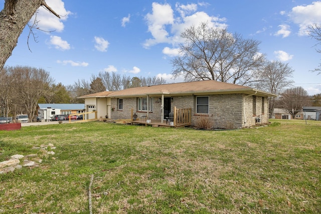 rear view of property featuring a lawn