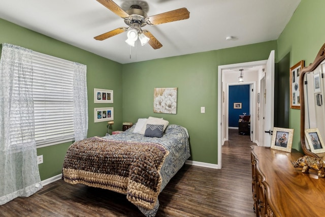 bedroom featuring dark wood finished floors, baseboards, and a ceiling fan