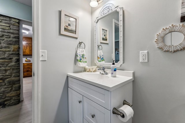 bathroom with vanity and wood finished floors