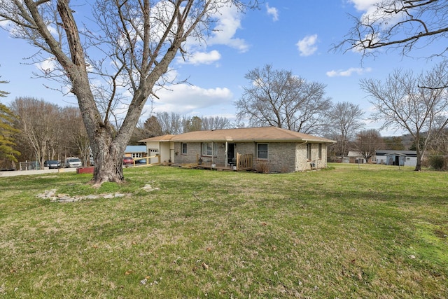 exterior space featuring brick siding and a front yard