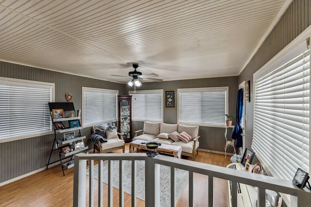 bedroom with baseboards, ceiling fan, and wood finished floors