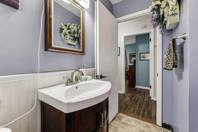 bathroom featuring vanity and a wainscoted wall