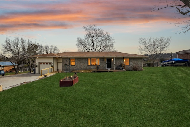 ranch-style house featuring a lawn, concrete driveway, and a garage