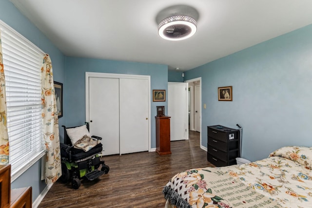 bedroom featuring baseboards, a closet, and dark wood-style floors