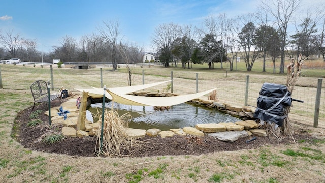 view of yard with a rural view and fence