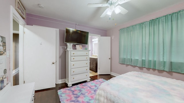 bedroom with connected bathroom, visible vents, baseboards, dark wood-style flooring, and ceiling fan