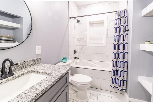 bathroom featuring vanity, marble finish floor, tiled shower / bath combo, and toilet