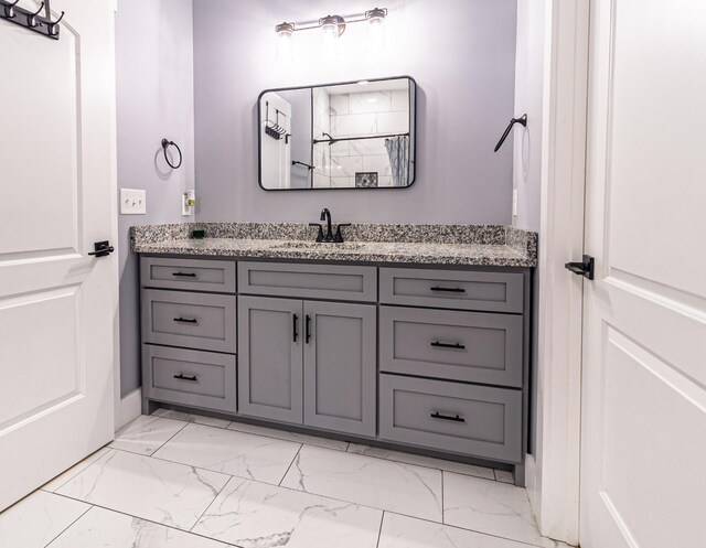 bathroom with marble finish floor and vanity