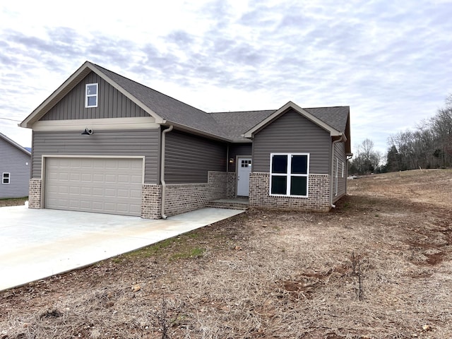 view of front facade featuring brick siding, roof with shingles, concrete driveway, board and batten siding, and an attached garage