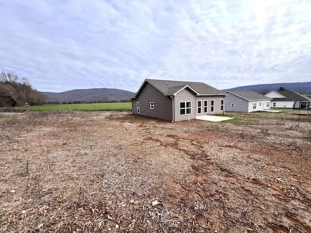 back of house with a patio area and a mountain view