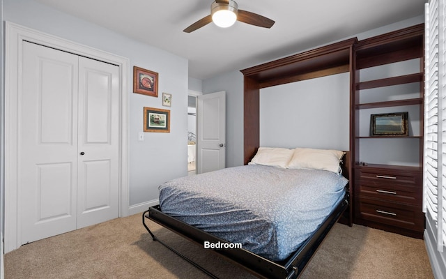 carpeted bedroom with ceiling fan and a closet