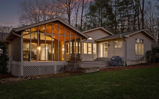 rear view of house featuring a yard and crawl space