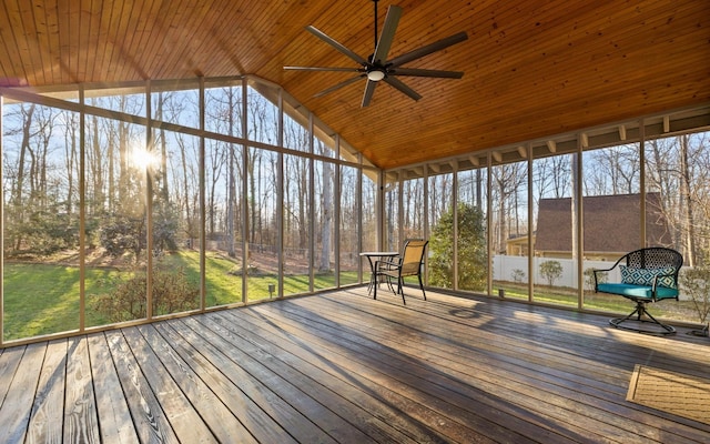 unfurnished sunroom featuring vaulted ceiling, wooden ceiling, and a ceiling fan