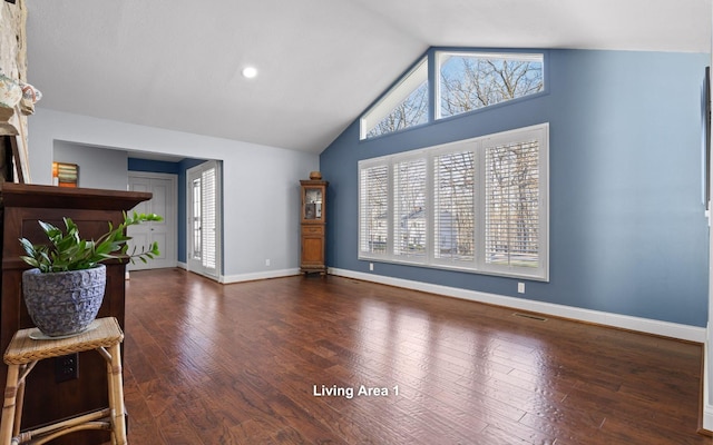 interior space with plenty of natural light, high vaulted ceiling, baseboards, and dark wood finished floors