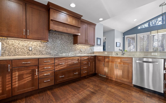 kitchen with dishwasher, lofted ceiling, dark wood-style flooring, light countertops, and a sink