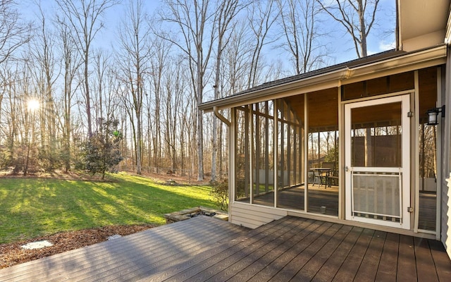 wooden terrace with a lawn and a sunroom