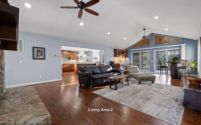 living area with recessed lighting, a ceiling fan, dark wood finished floors, baseboards, and high vaulted ceiling