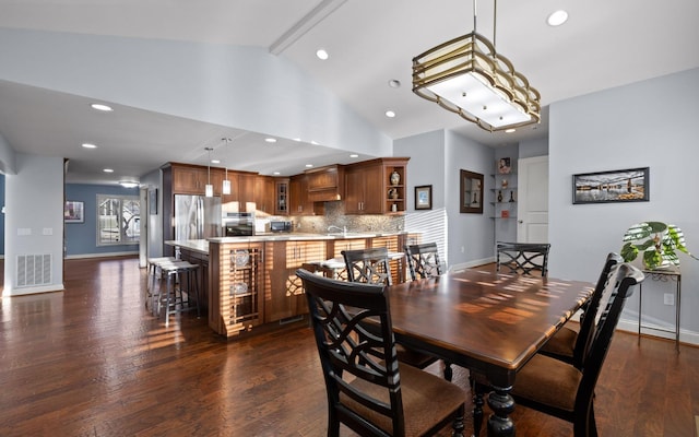 dining area featuring baseboards, beam ceiling, visible vents, and dark wood-type flooring