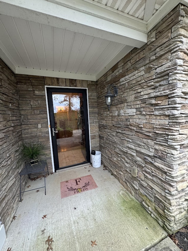 doorway to property with stone siding