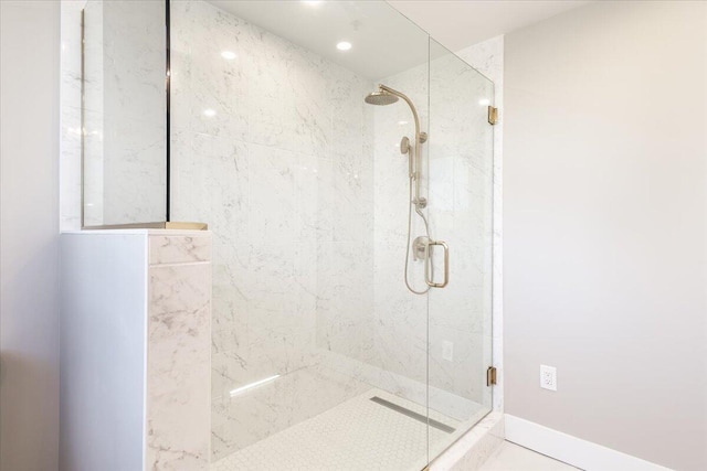 full bathroom featuring a stall shower and baseboards